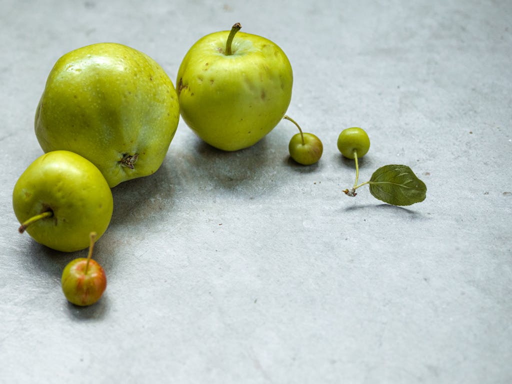 Fresh Green Fruits on Gray Concrete Surface